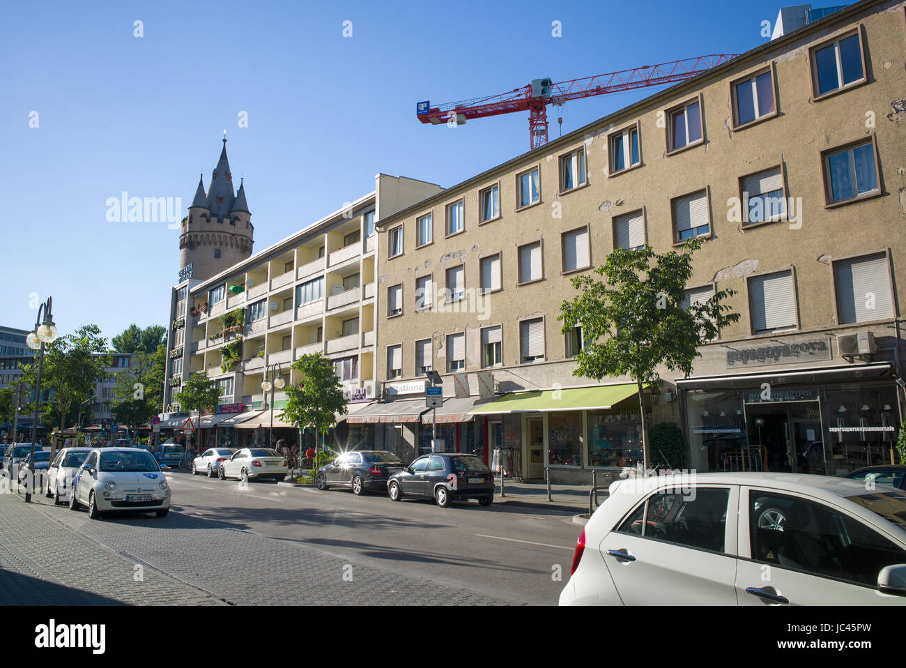 Low rise apartment building above shops wit former city fortification in background, Frankfurt am Main, Germany Stock Photo
