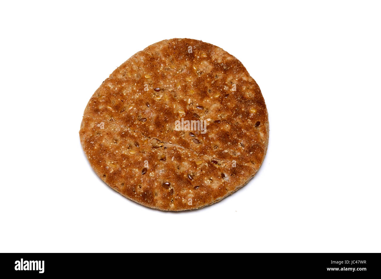 A small loaf of multigrain flat bread from above on white Stock Photo