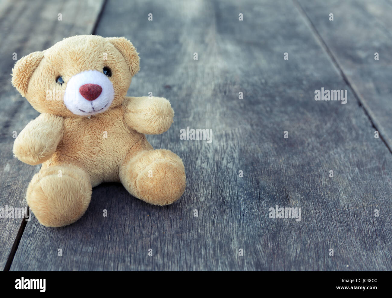 teddy bear on wood background vintage light Stock Photo - Alamy