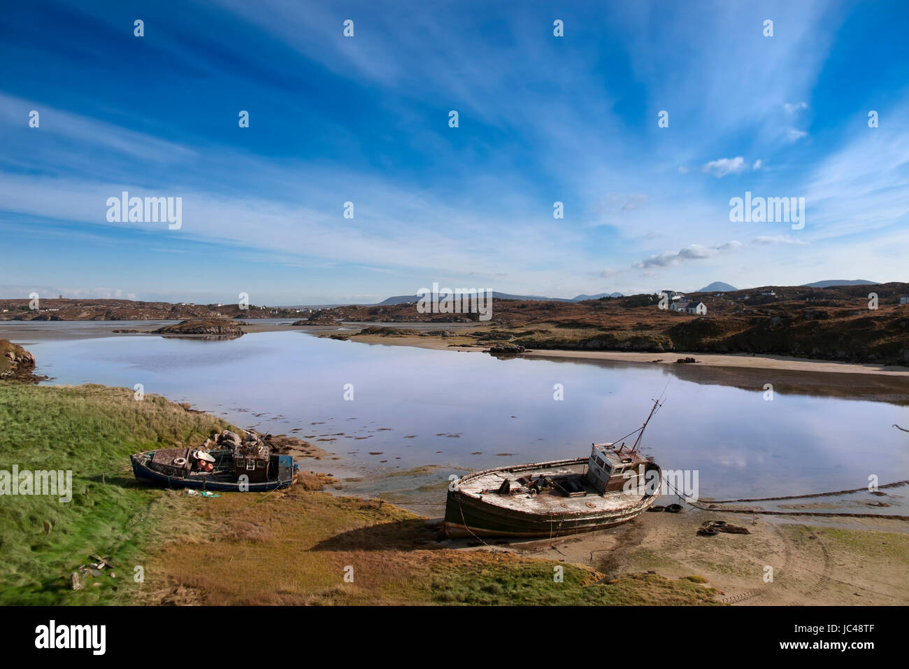 two old fishing boats beached on a coastal beach in county Donegal