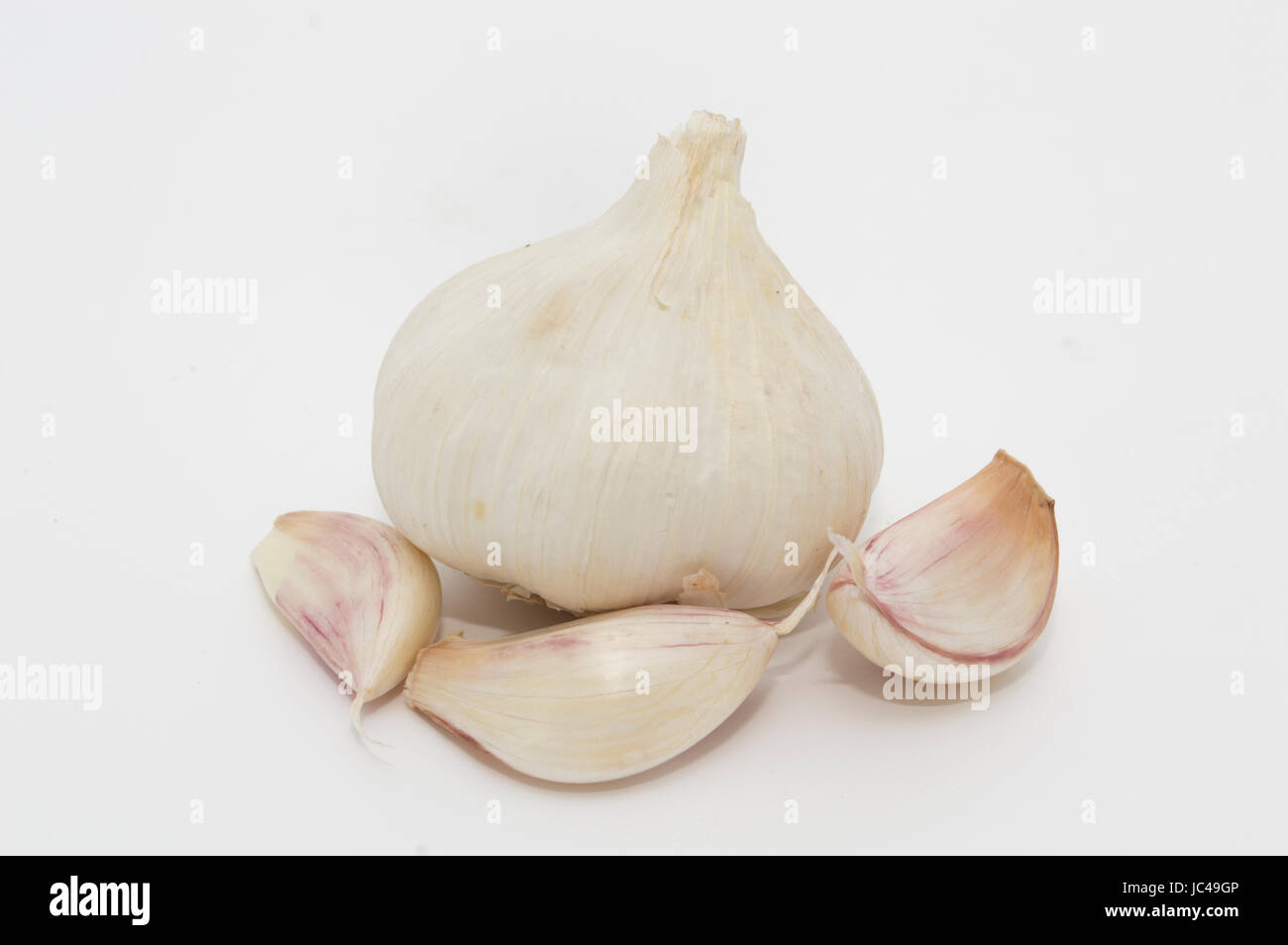 head with three cloves of garlic on a white background Stock Photo - Alamy