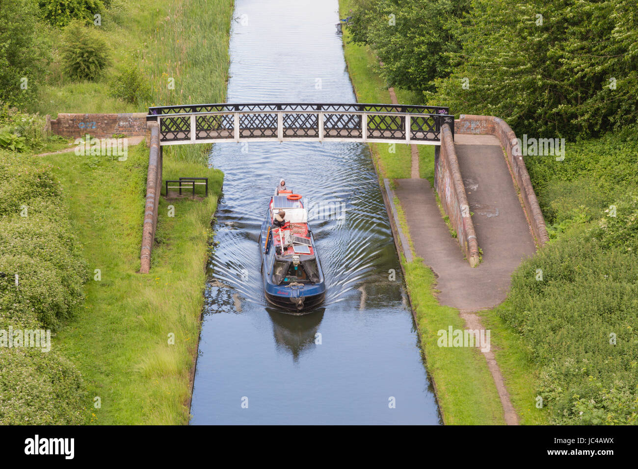 Canal boat travelling on the Birmingham to Wolverhampton canal, West Midlands Black Country Coseley UK Stock Photo