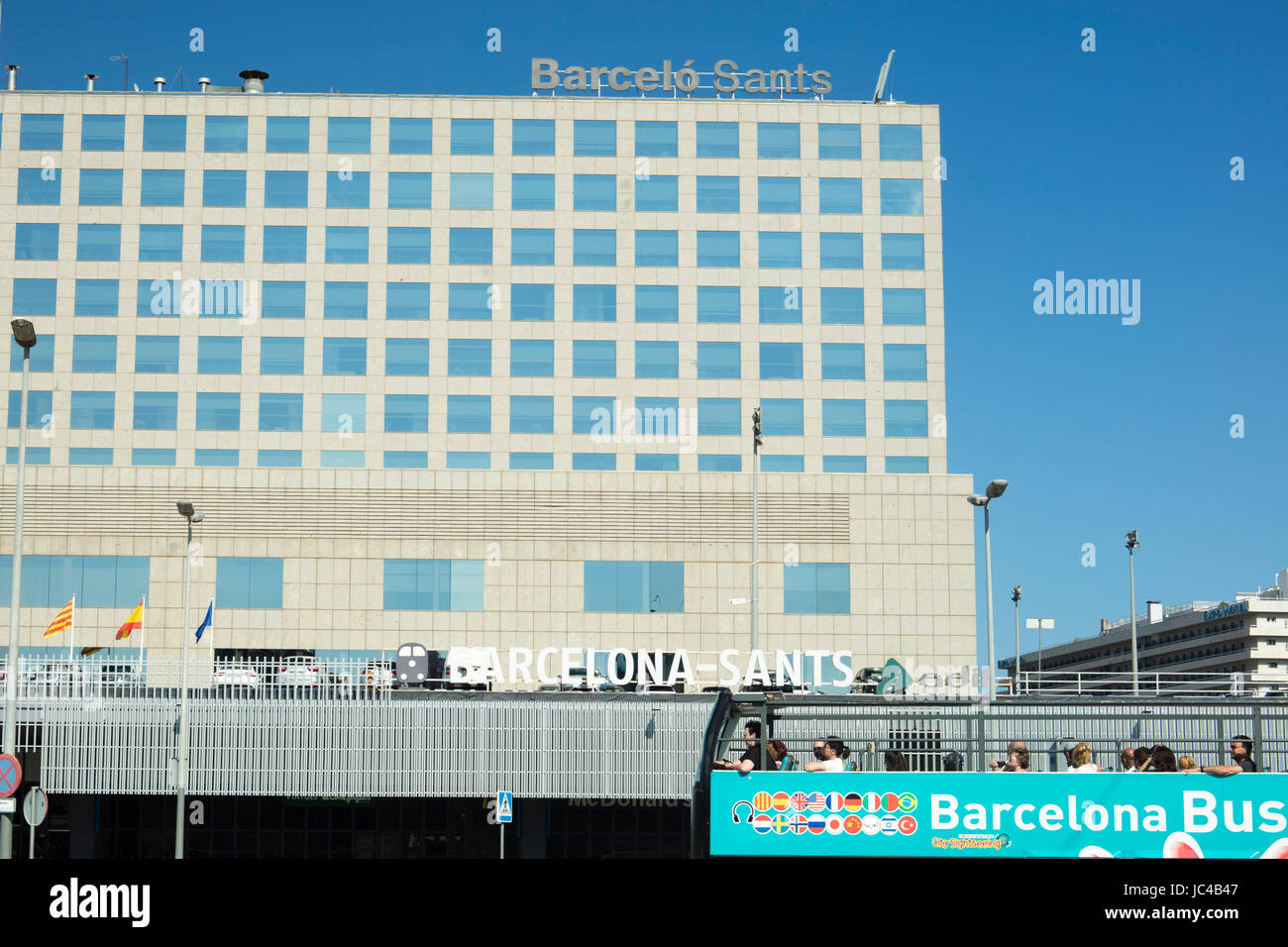Barcelona, Spain - September 27. 2016: Building of Barcelo Sants railway station in Barcelona city and a touristic bus, which drives through the city  Stock Photo