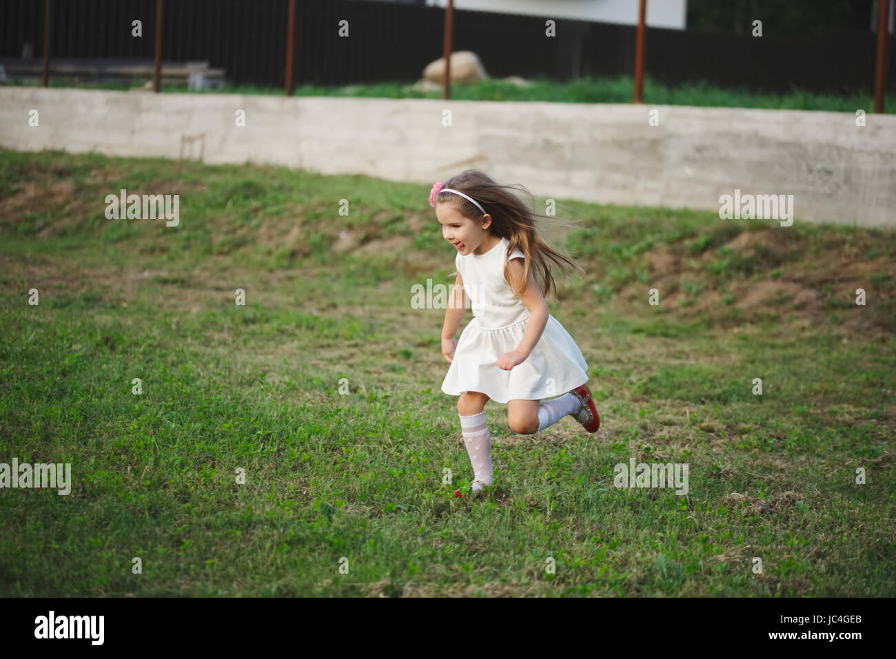 little beautiful running girl outside Stock Photo