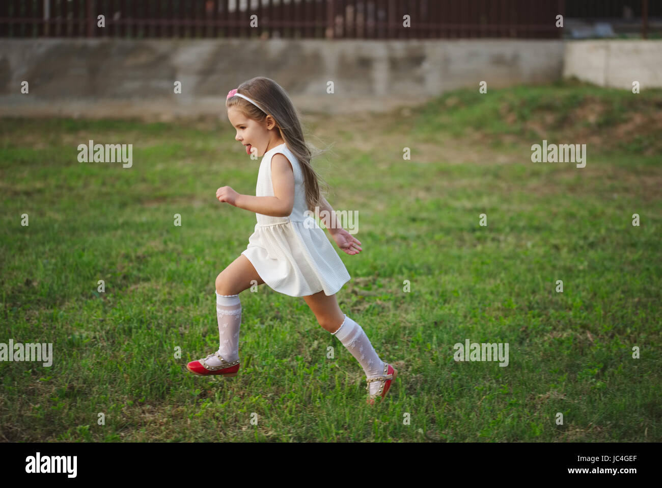 little beautiful running girl outside Stock Photo