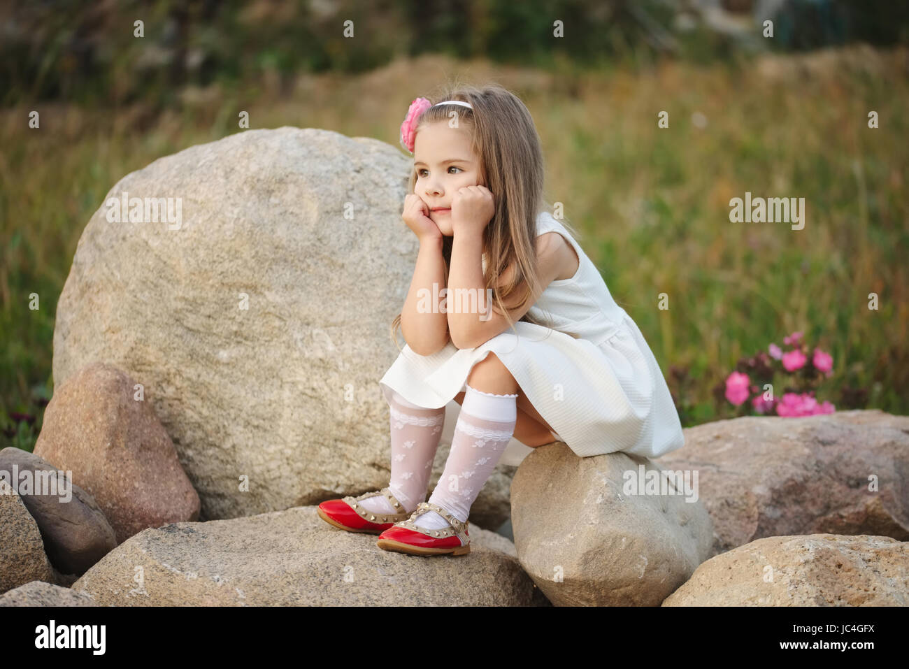 little girl on the big stone Stock Photo