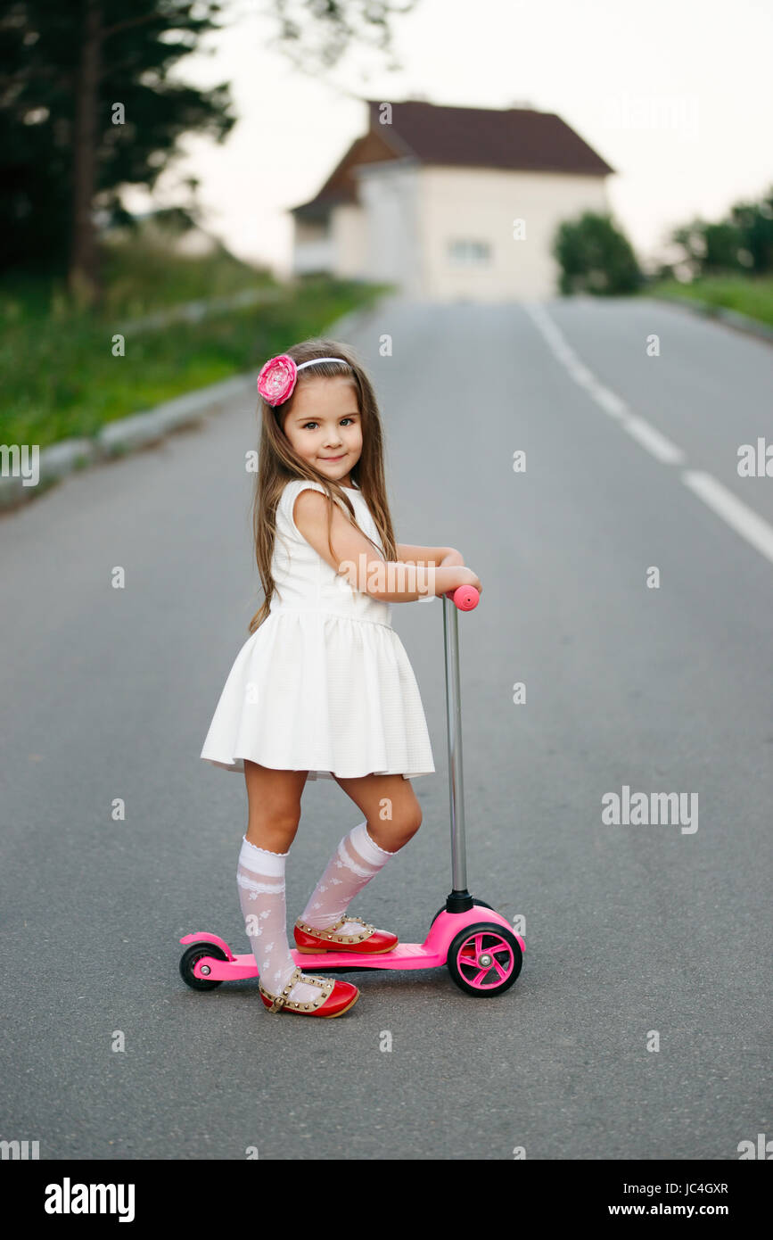 beautiful girl with scooter on the road Stock Photo Alamy