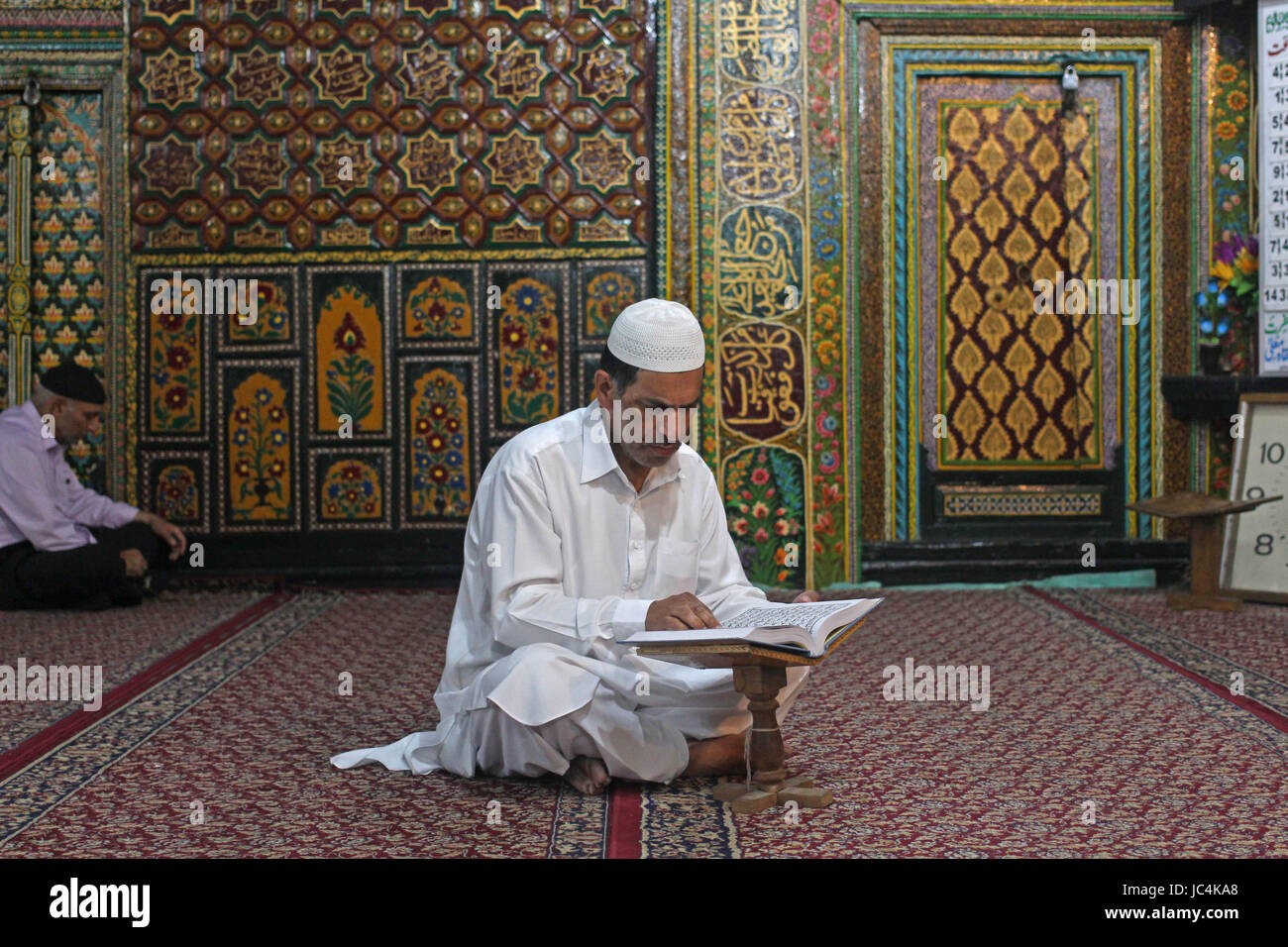 A Kashmiri Muslim man recites the Quran at the Shah-i-Hamdaan shrine ...