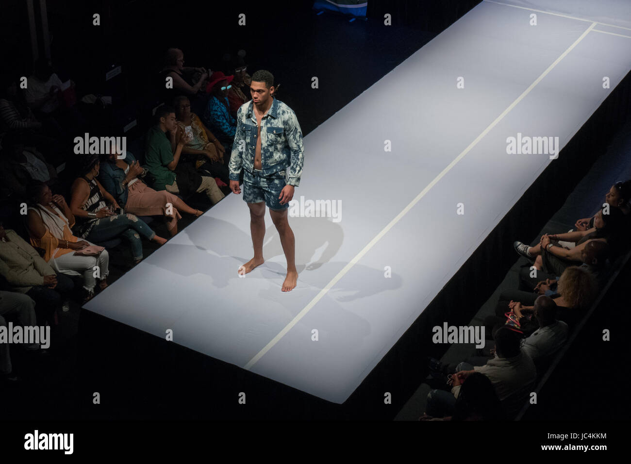an african male model at the end of a fashion runway Stock Photo