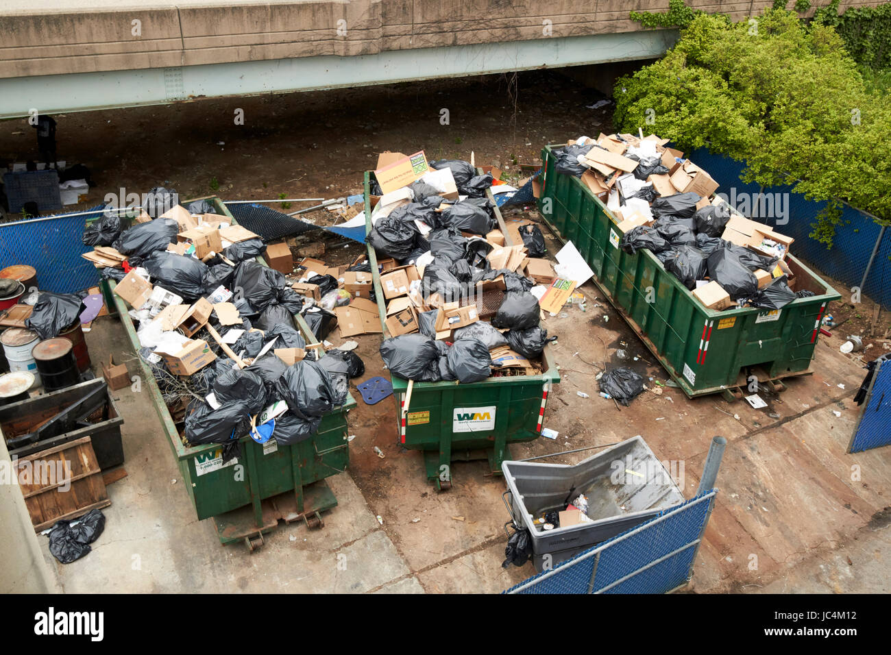 full overflowing commercial waste dumpsters Philadelphia USA Stock Photo
