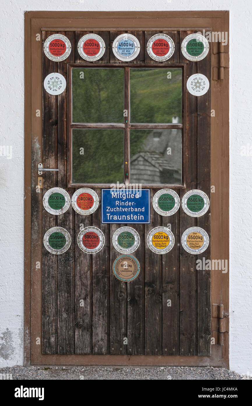 Stable door with milk yield plaques, Upper Bavaria Germany Stock Photo