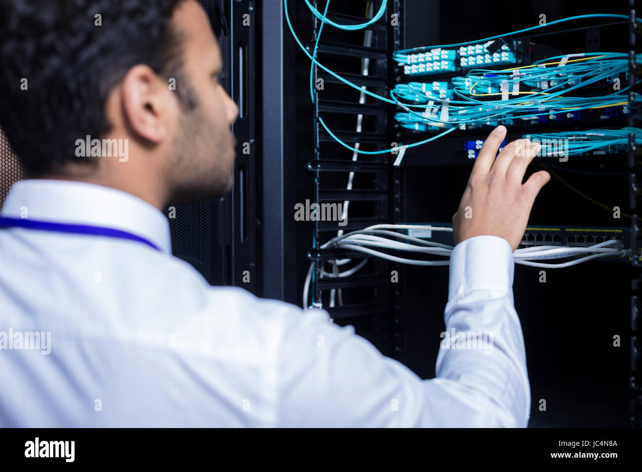 Professional IT administrator checking internet cables Stock Photo - Alamy