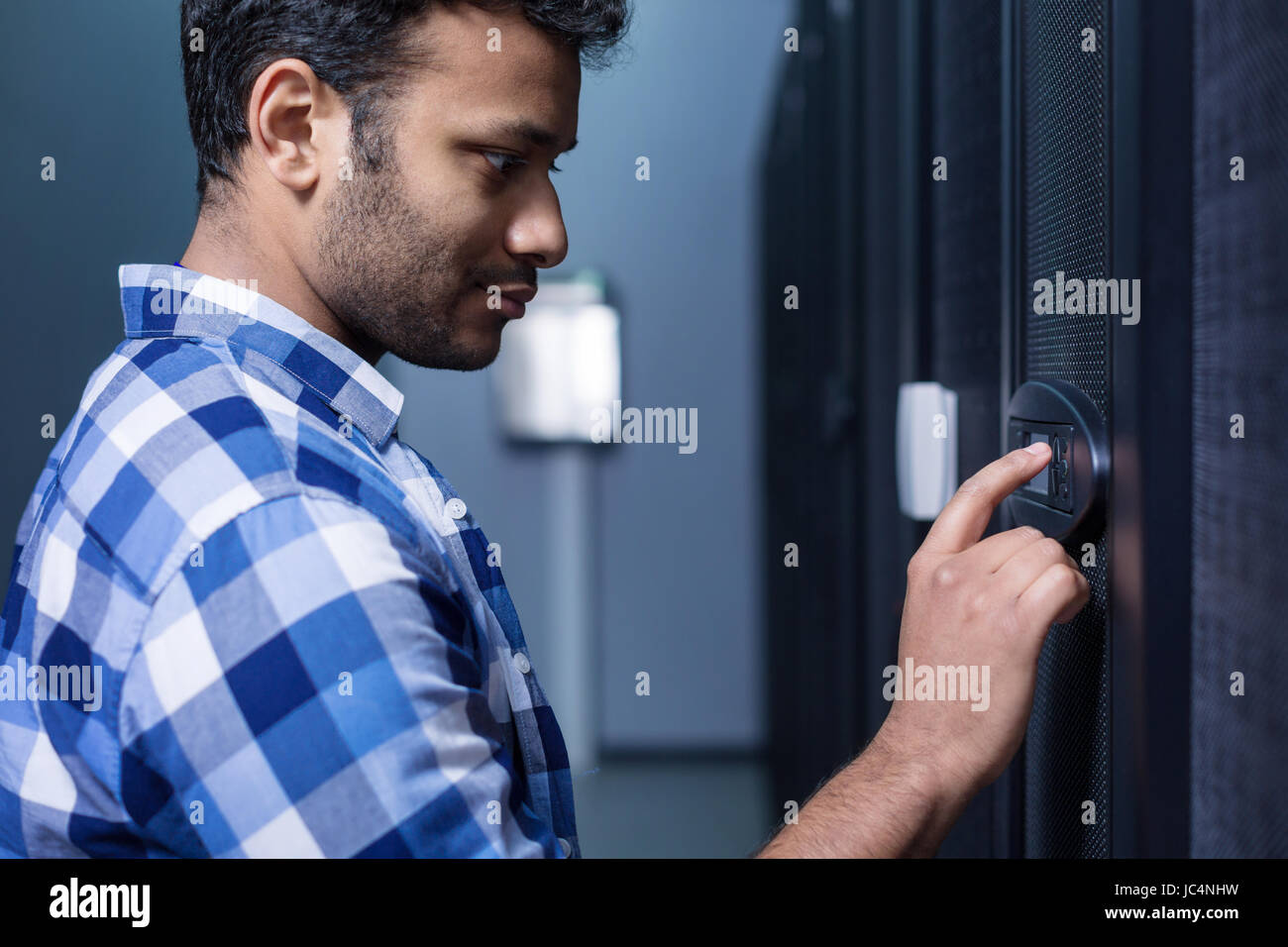 Serious pleasant man looking at the control panel Stock Photo - Alamy