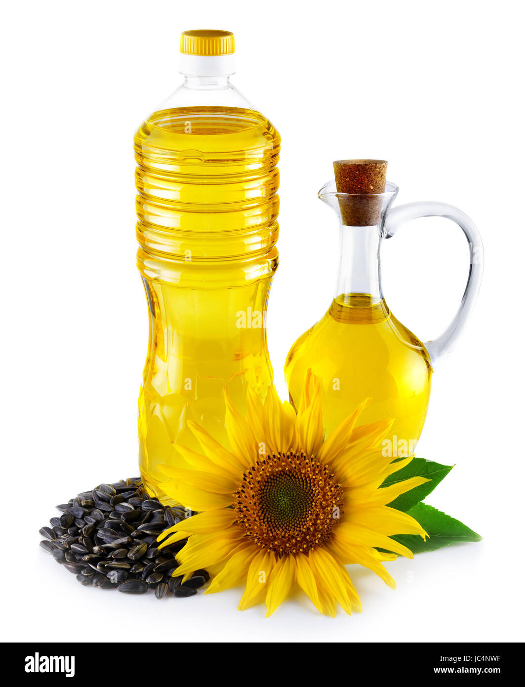 Jug and bottle with sunflower oil with seeds isolated on white Stock Photo