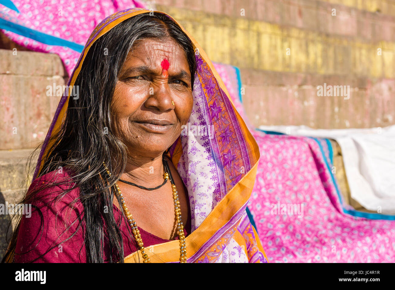 Portrait of a woman at the holy river Ganges at Dashashwamedh Ghat, Main Ghat, in the suburb Godowlia Stock Photo