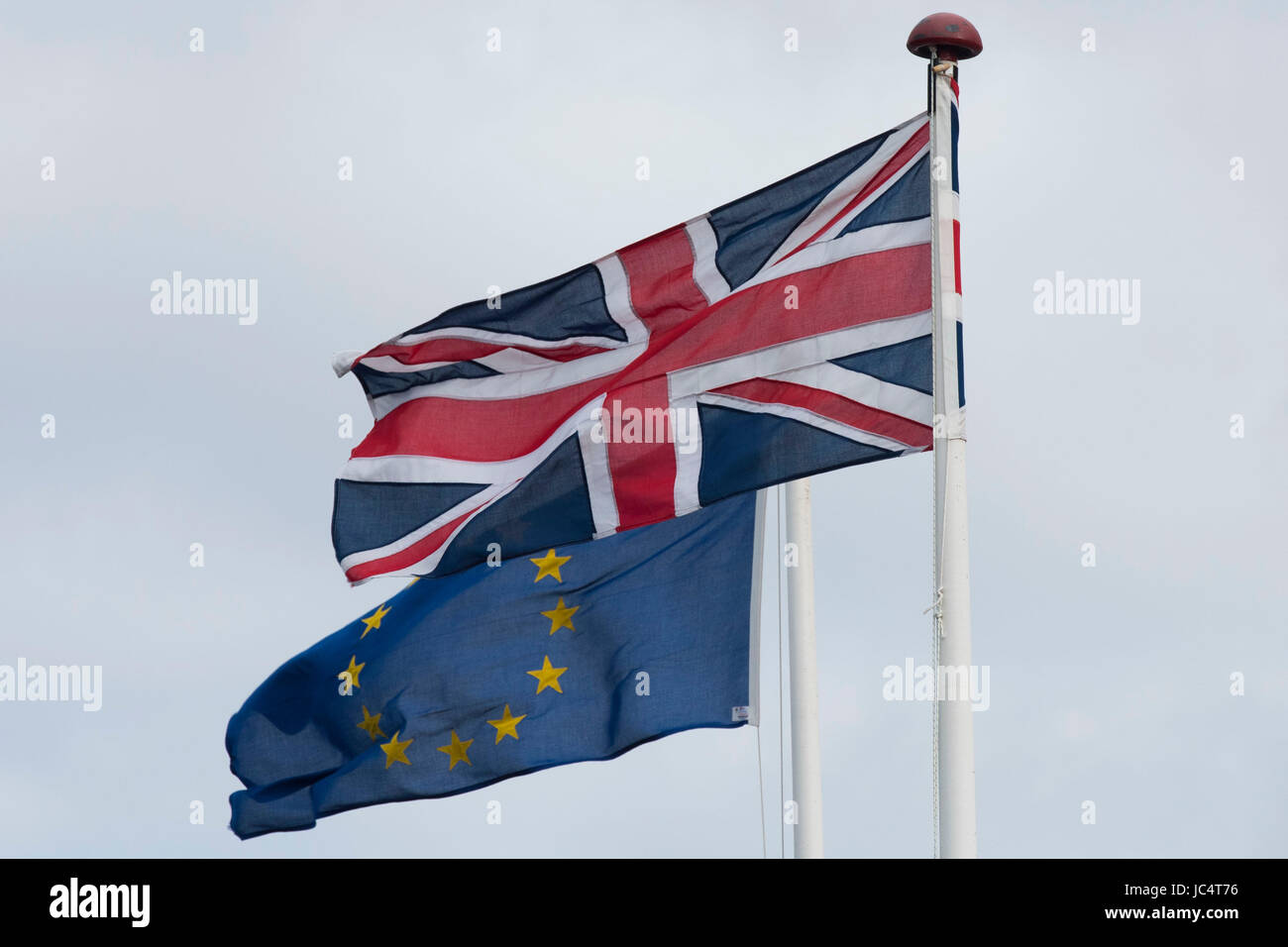 European Union and British Union Jack flags blow in the wind. The UK voted to leave the EU in a referendum. Stock Photo