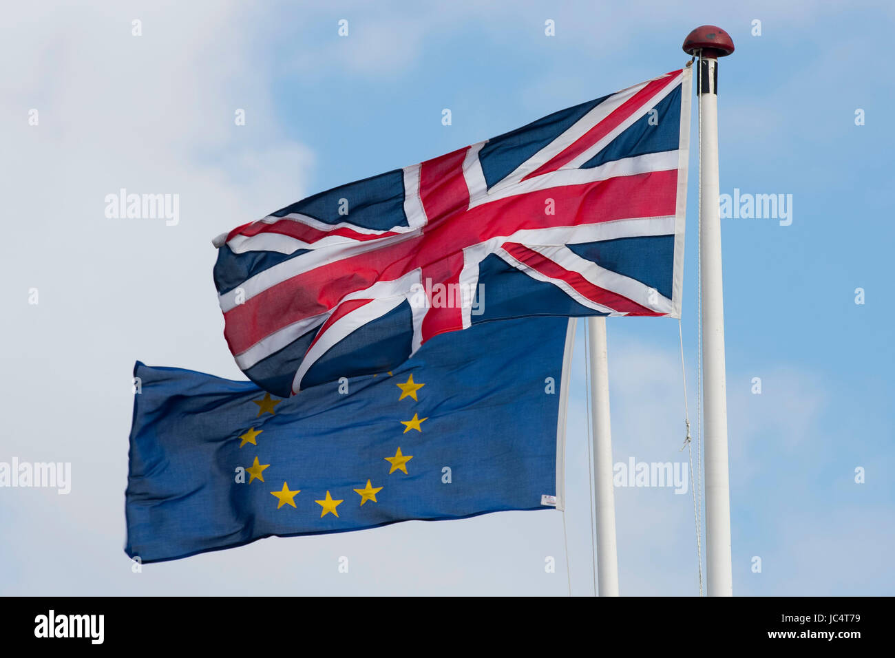 European Union and British Union Jack flags blow in the wind. The UK voted to leave the EU in a referendum. Stock Photo