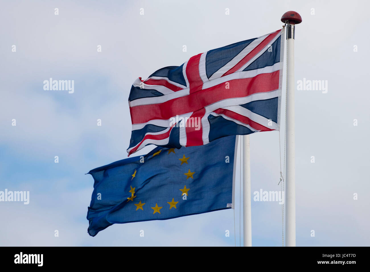 European Union and British Union Jack flags blow in the wind. The UK voted to leave the EU in a referendum. Stock Photo