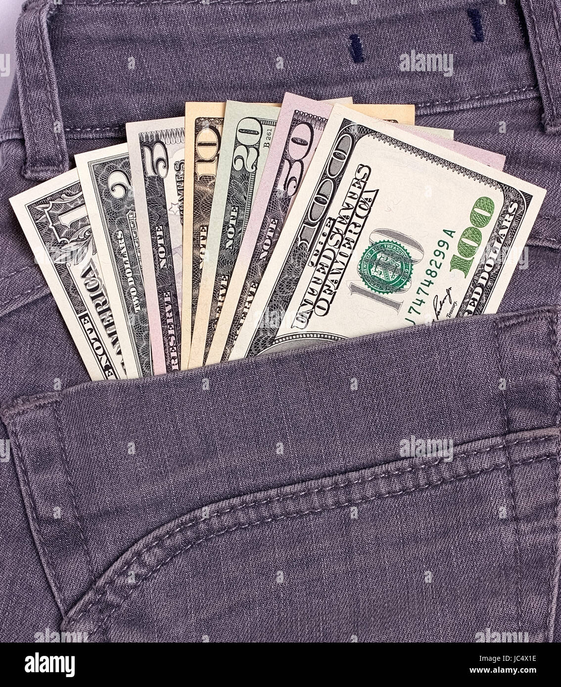 Dollars bills in black jeans back pocket Stock Photo