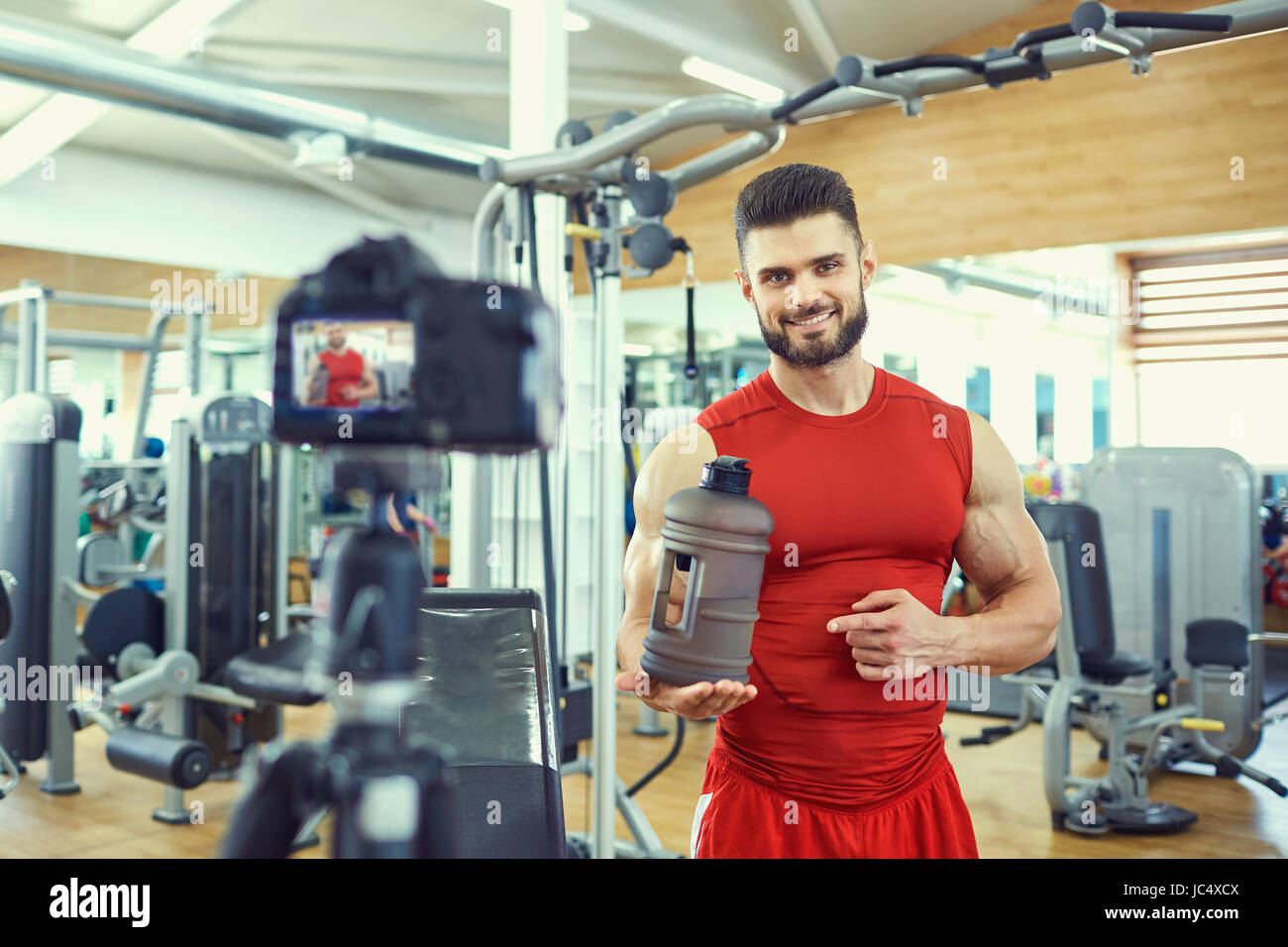 Blogger athlete makes a video about healthy eating in the gym Stock Photo