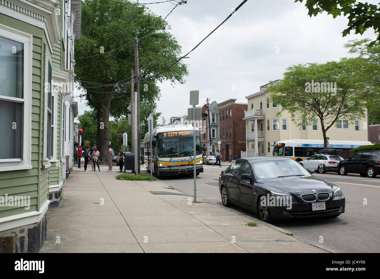 A city bus makes a stop in South Boston in Boston, Massachusetts Stock Photo