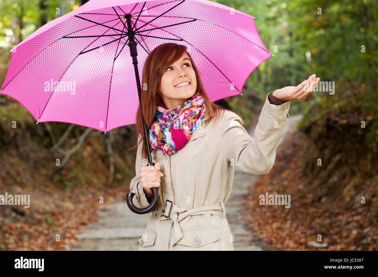 Beautiful girl with umbrella checking for rain Stock Photo - Alamy