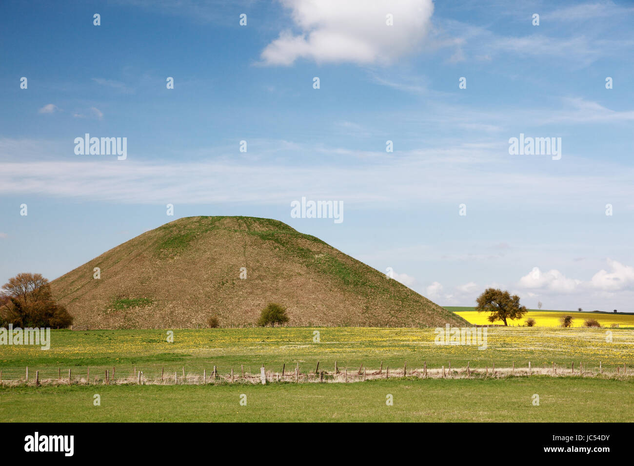The prehistoric mound of Silbury Hill, a World Heritage site in Wiltshire, England, next to the A4 road Stock Photo