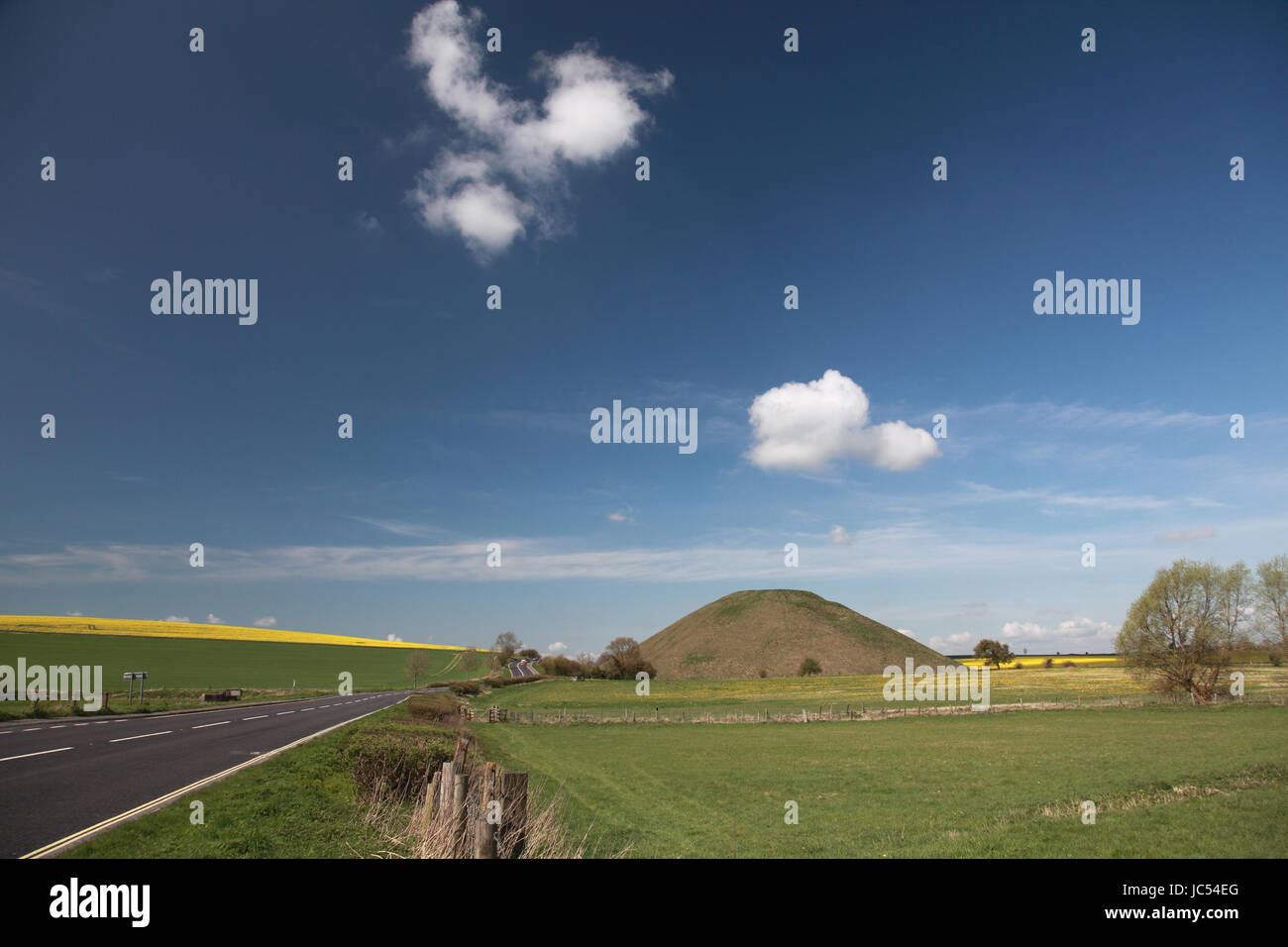 The prehistoric mound of Silbury Hill, a World Heritage site in Wiltshire, England, next to the A4 road Stock Photo