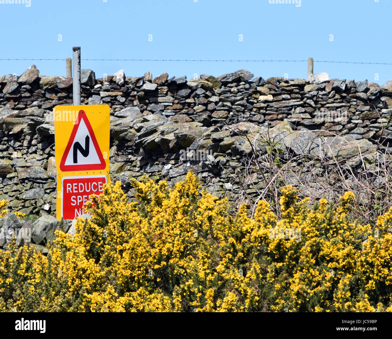 Double bend first to right road sign in Britain Stock Photo