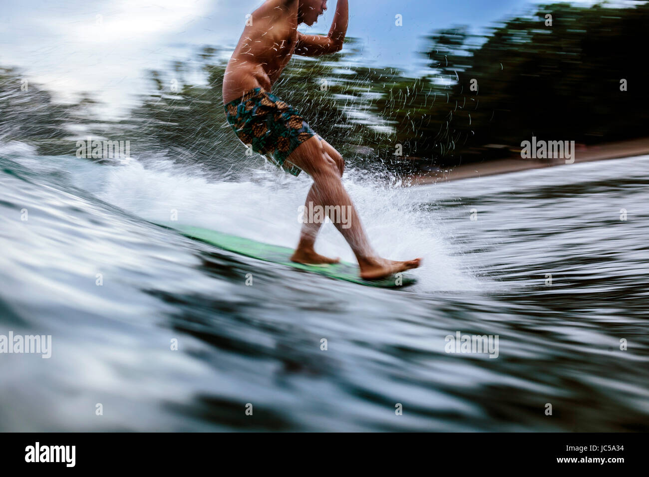 Male surfer on wave Stock Photo