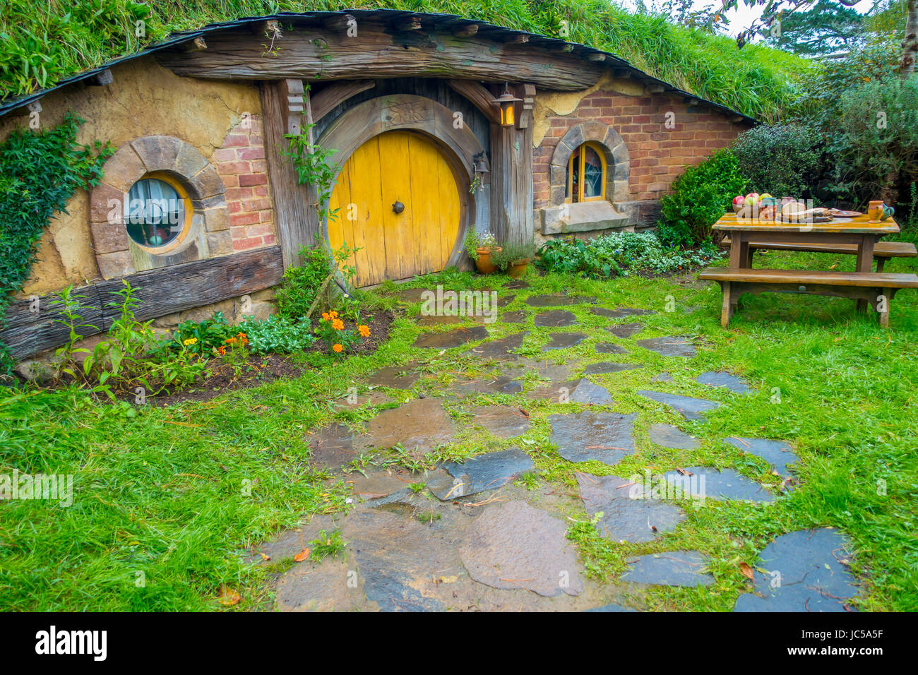 NORTH ISLAND, NEW ZEALAND- MAY 16, 2017: Hobbit house with yellow door, hobbiton movie set, site made for movies: Hobbit and Lord of the ring in Matam Stock Photo