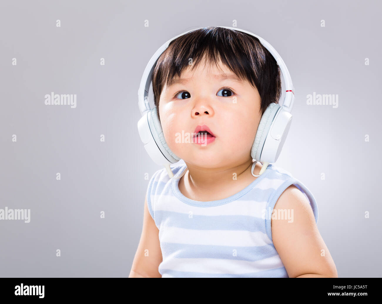 Baby boy wearing headphone Stock Photo Alamy