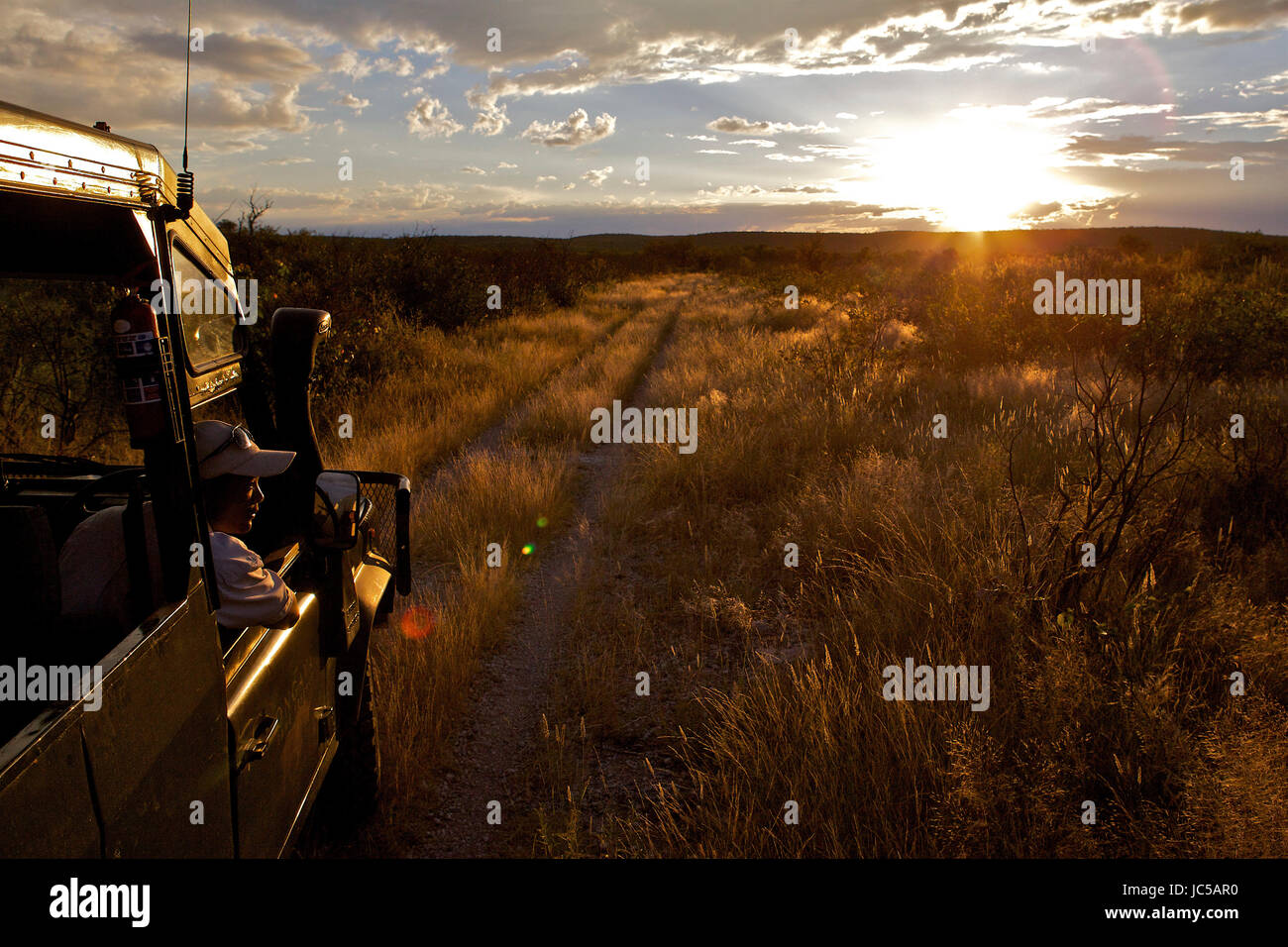 Watching sunset in Africa Stock Photo