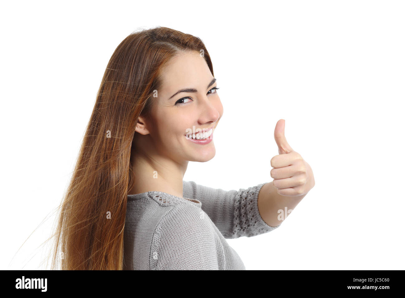 Back view of a happy woman making thumb up gesture isolated on a white ...