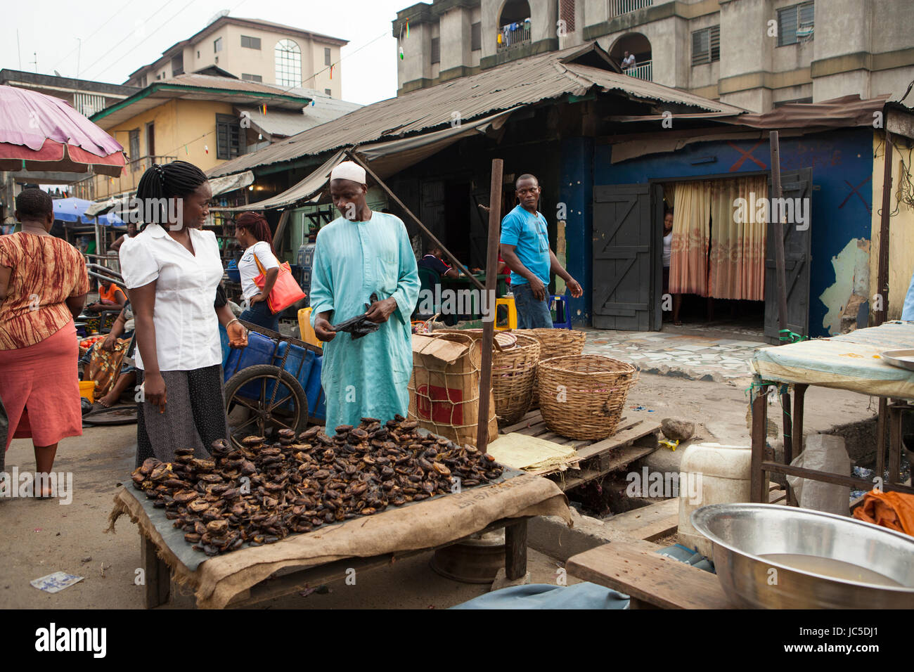 A woman selling dried food on a roadside stall, Nigeria, Africa Stock Photo