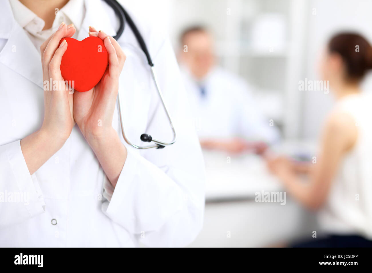 Female doctor with stethoscope holding heart Stock Photo - Alamy