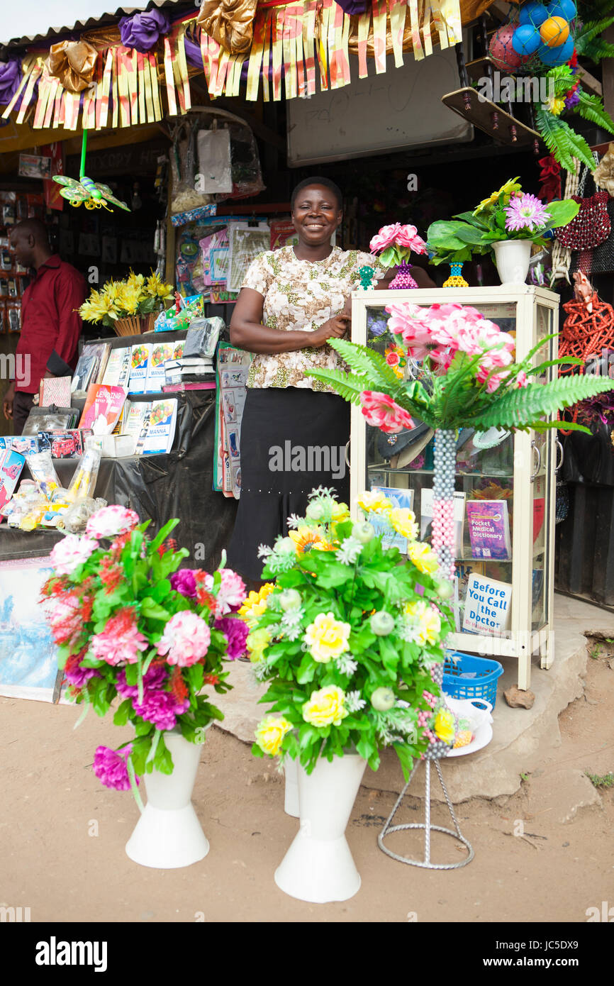 A female shop keeper outside her shop, Nigeria, Africa Stock Photo
