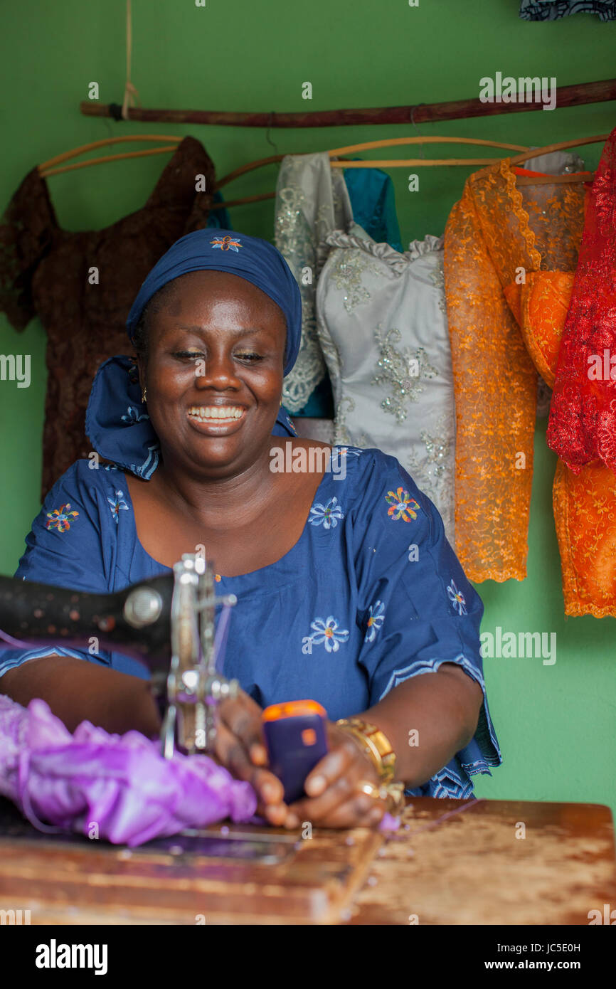 A female tailor at work at her sewing machine, Nigeria Africa Stock
