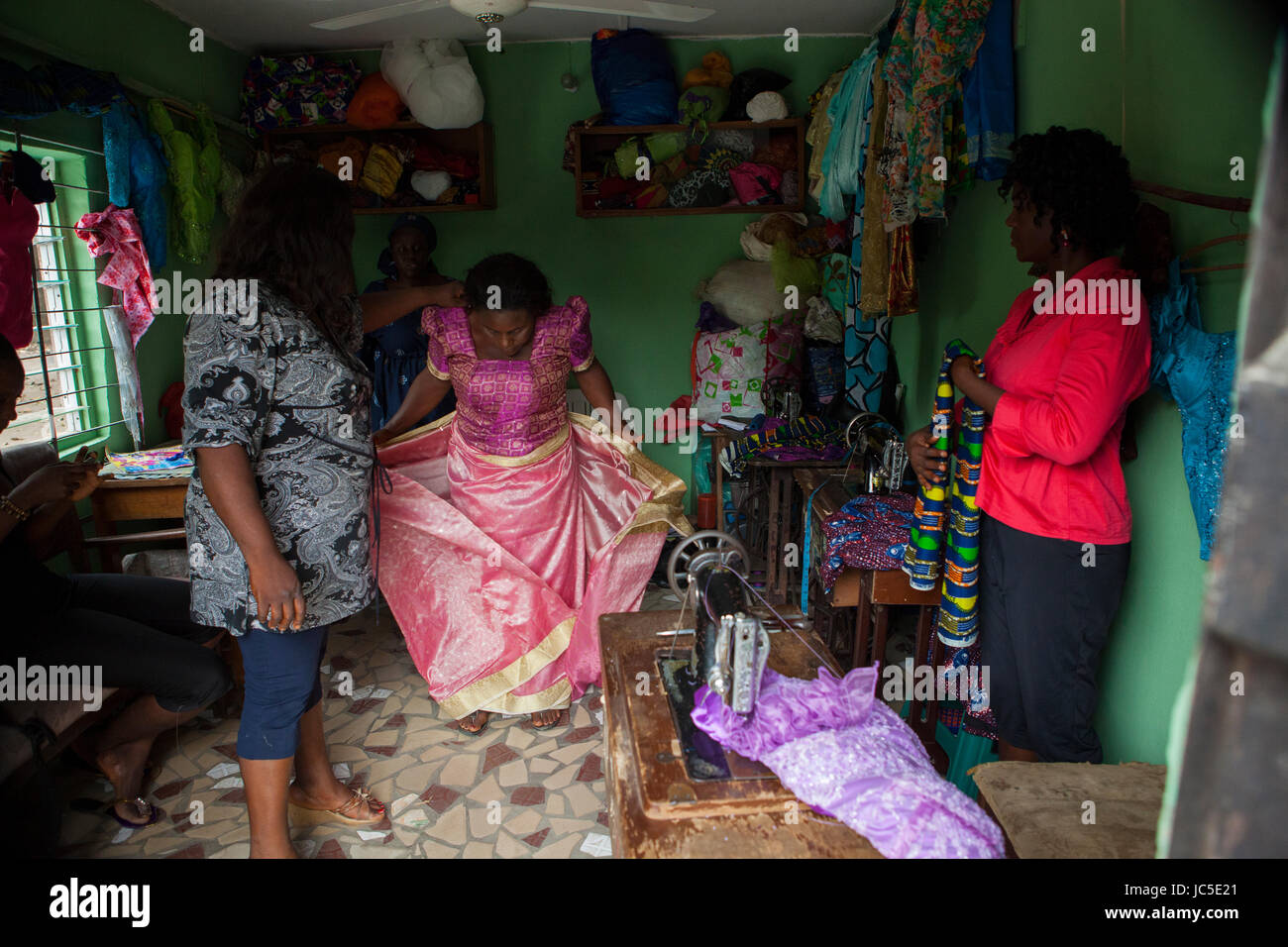 A woman tries on a dress in a local tailors, Nigeria, Africa Stock Photo