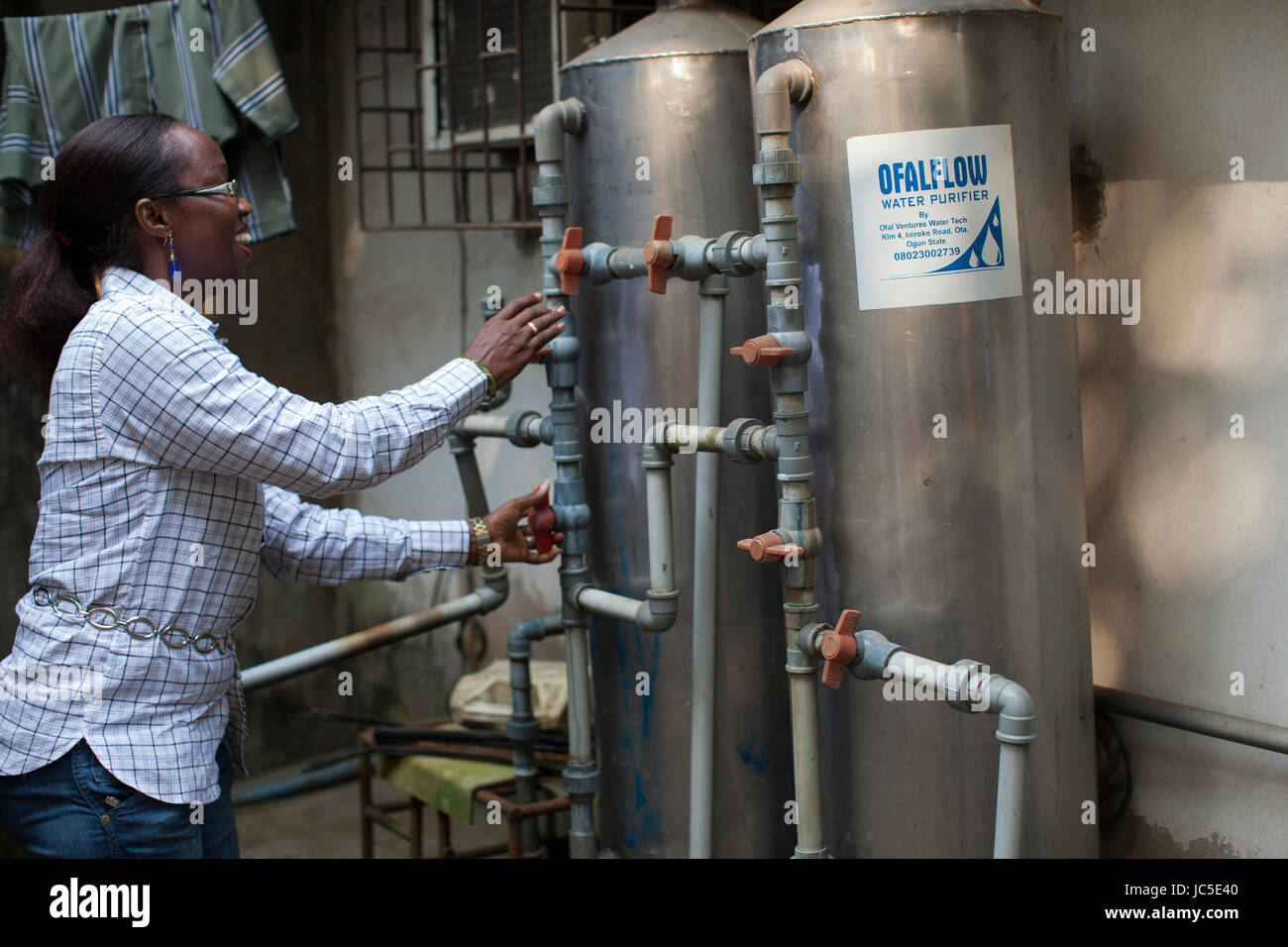 A business woman with her water filters, Nigeria, Africa Stock Photo