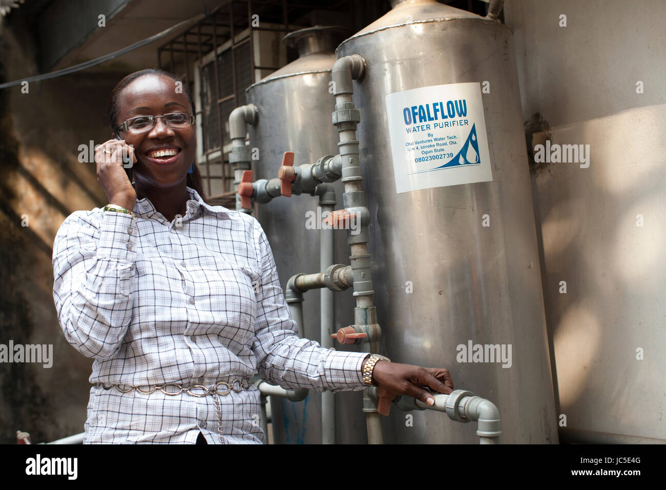 A business woman with her water filters, Nigeria, Africa Stock Photo