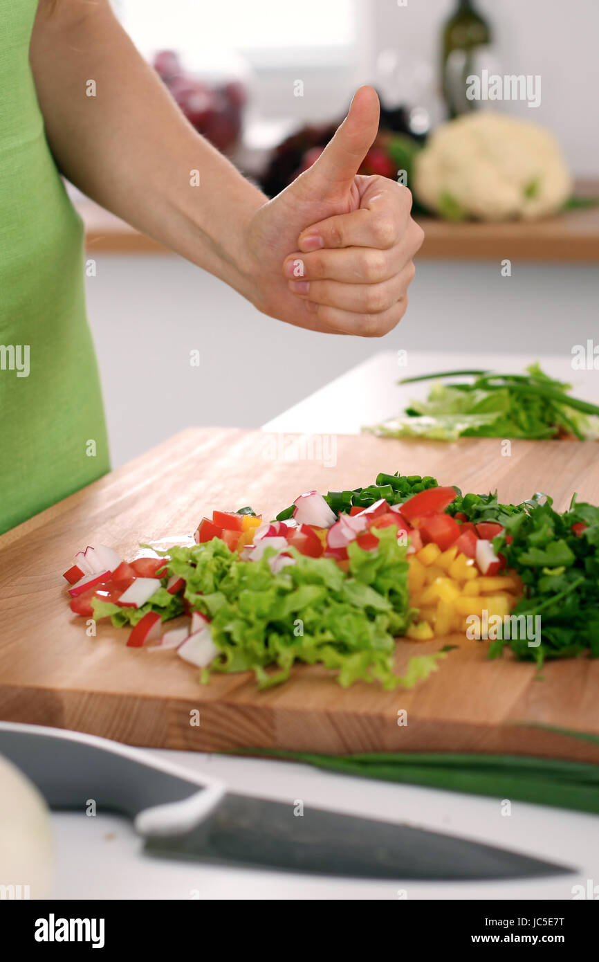 Close up of woman's hands cooking in the kitchen. Housewife offering ...