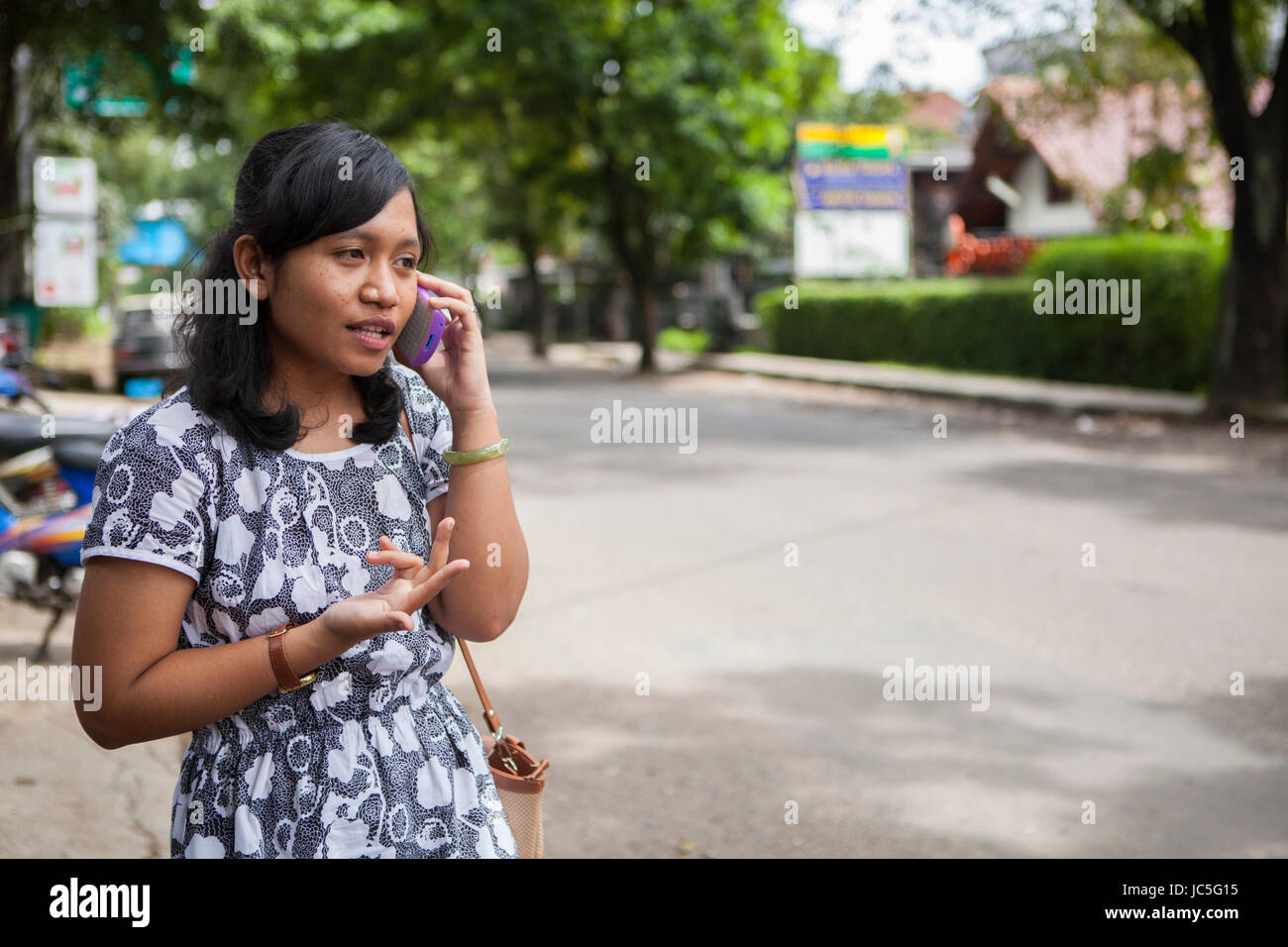 A woman talking on her mobile phone, Indonesia. Stock Photo
