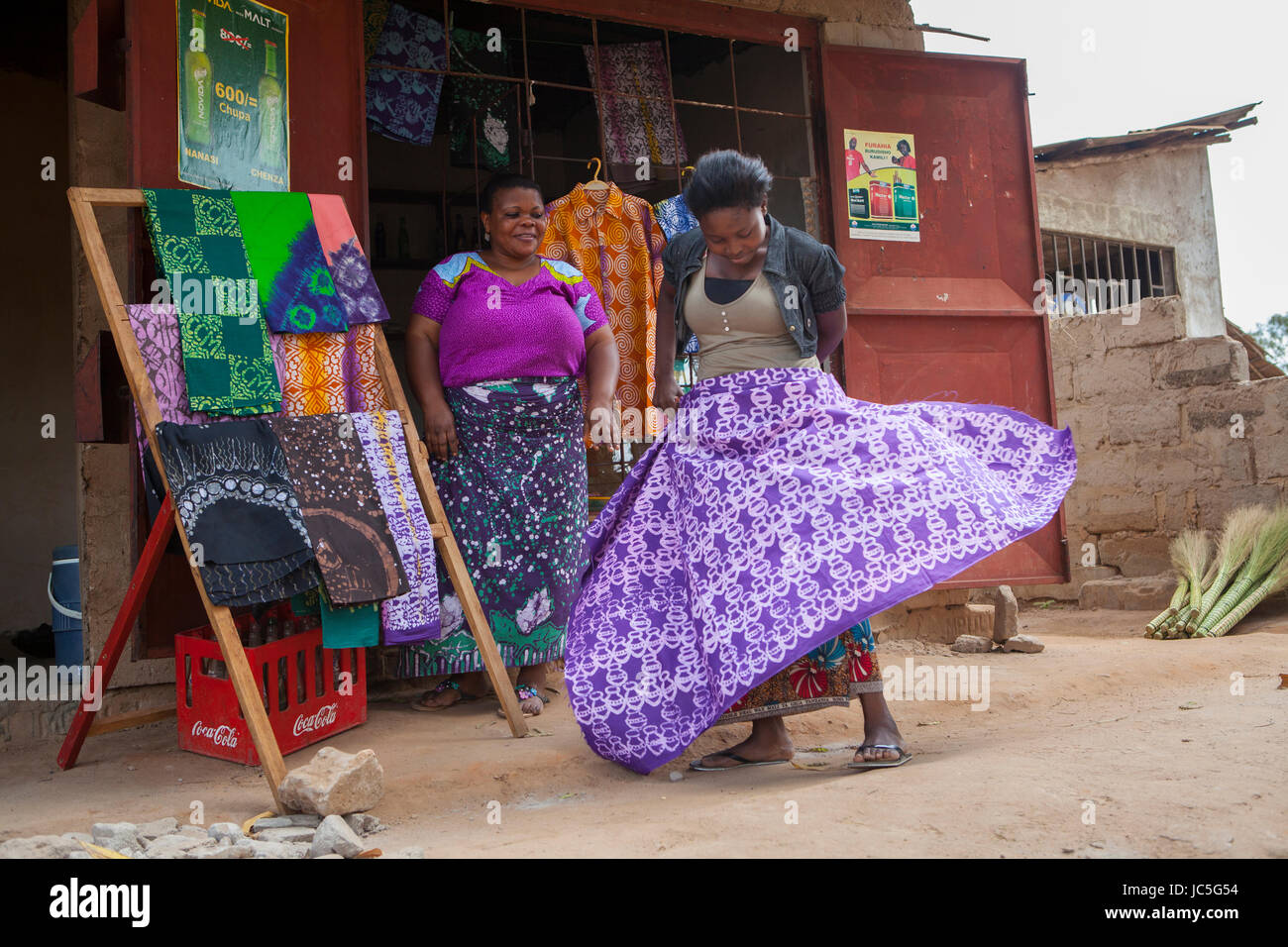 A female small business owner outside her Batik shop, Tanzania, Africa. Stock Photo
