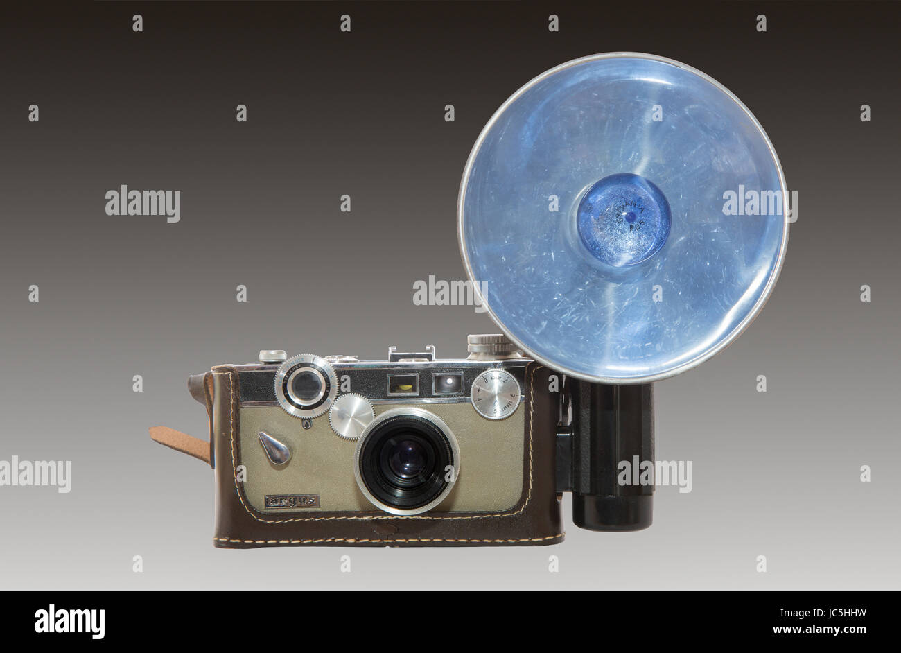 A 1958-1966 Argus C-3 match-matic 35mm camera with a blue Sylvania flash bulb and reflector-The design of the camera is attributed to Gustave Fassin. Stock Photo