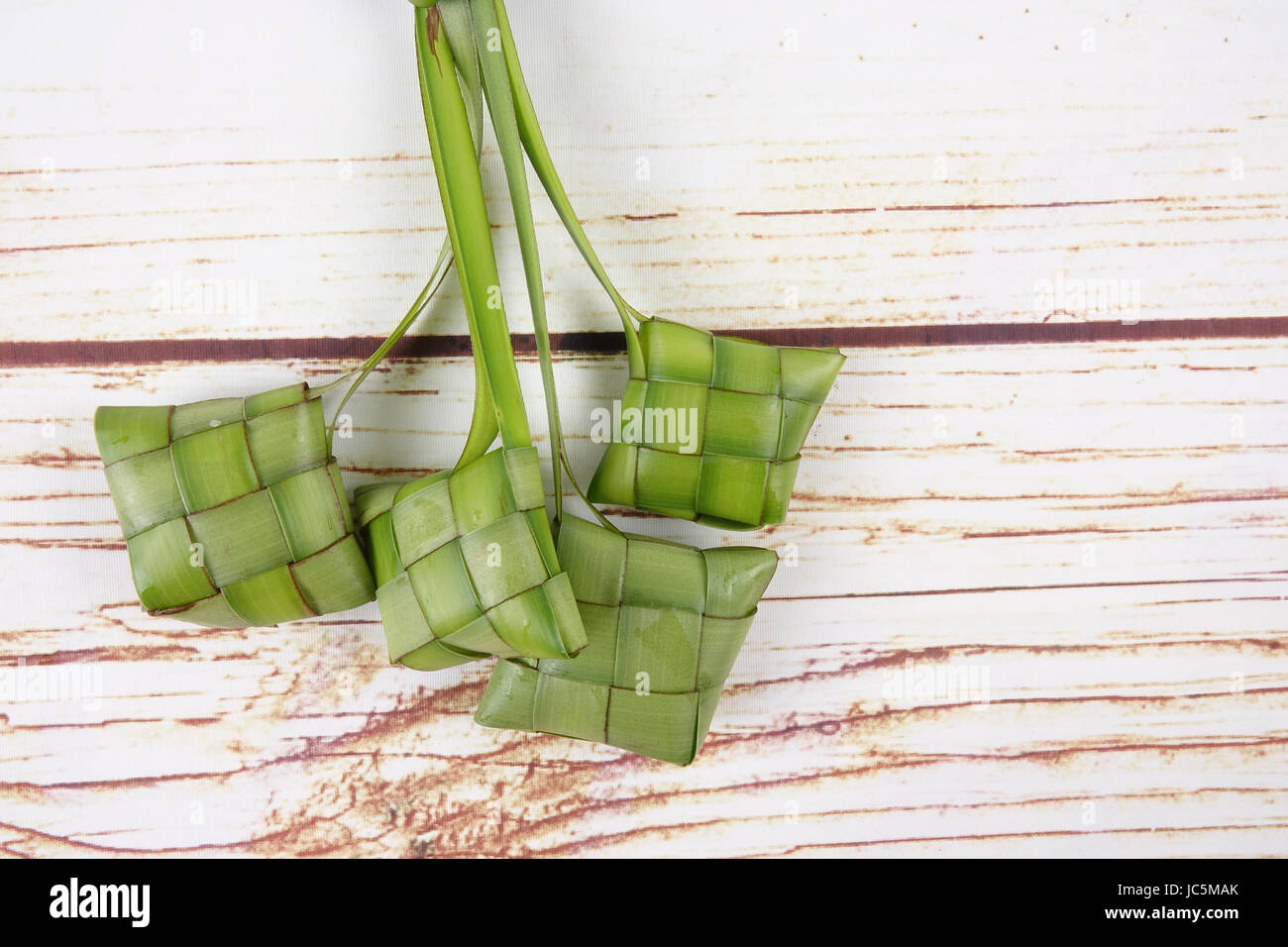 Making of Ketupat, a natural rice casing made from young coconut leaves ...