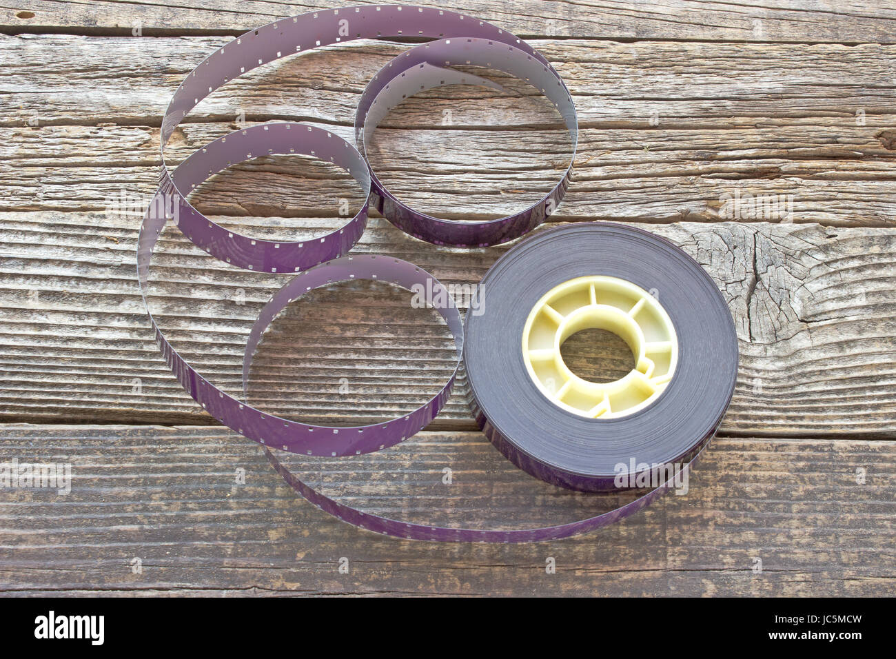 16 mm film reel on wooden background Stock Photo