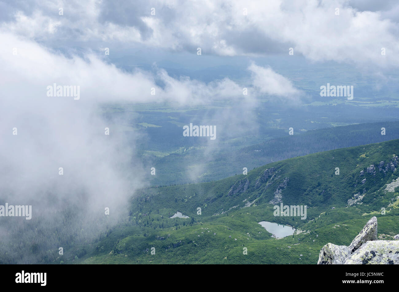 Tatra peaks in the clouds. Look from the top of the mountain Stock ...
