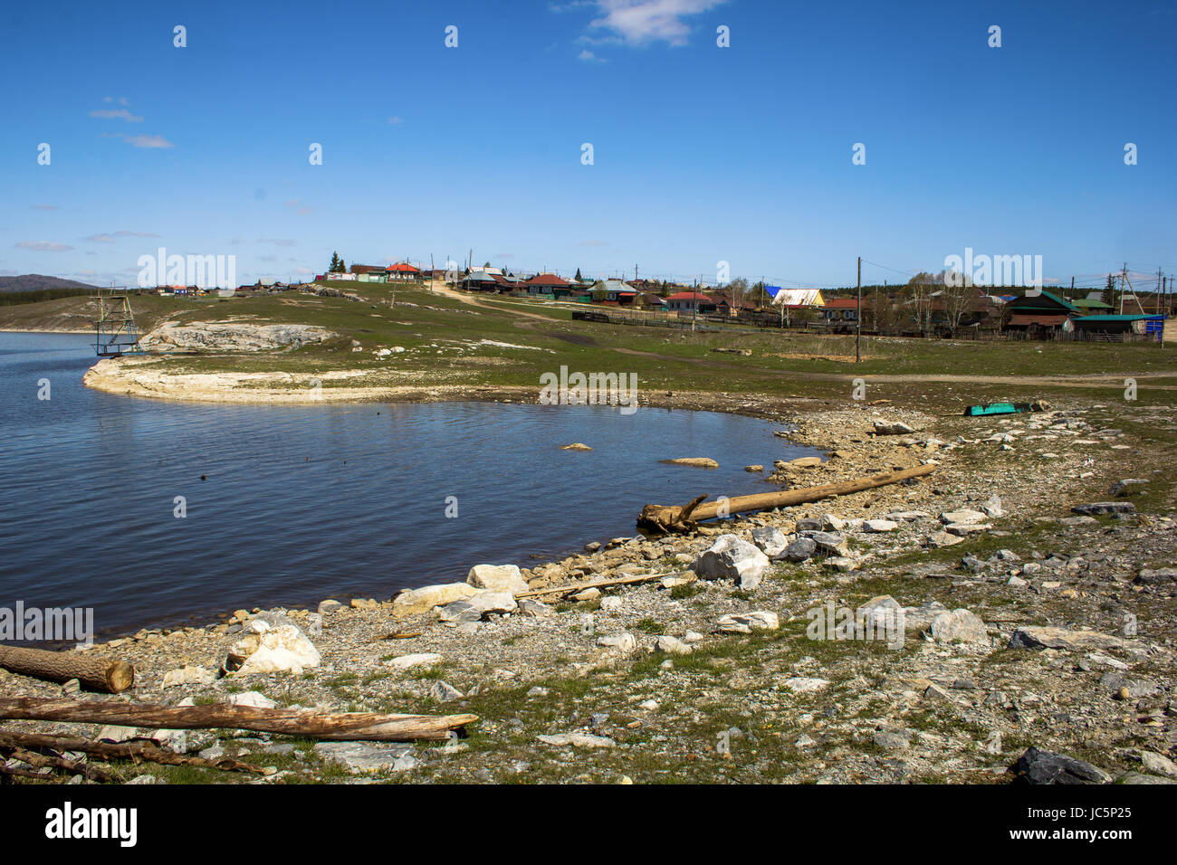 landscape with the lake shore and the village Stock Photo