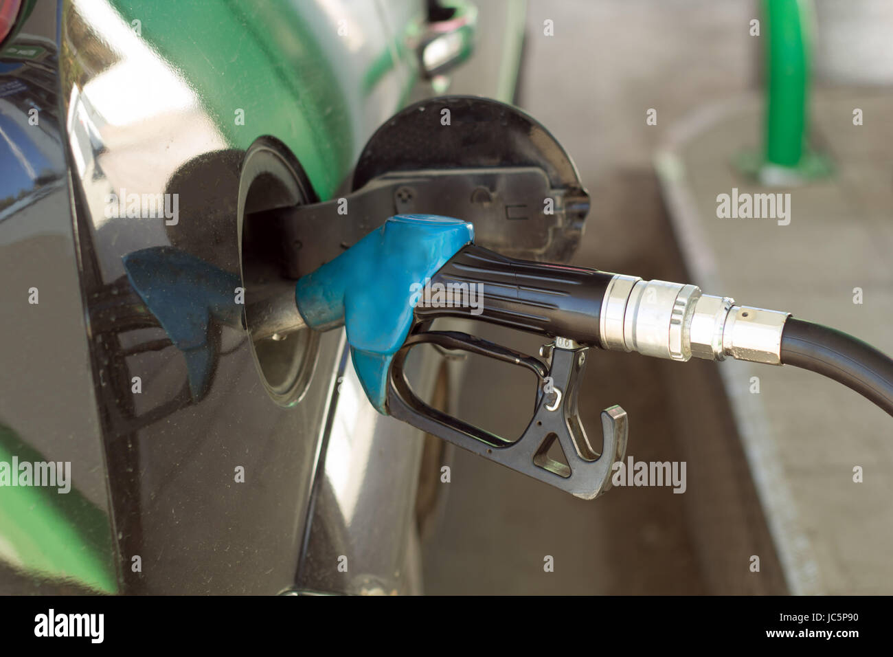 Opened tank and fuel fuel nozzle Stock Photo